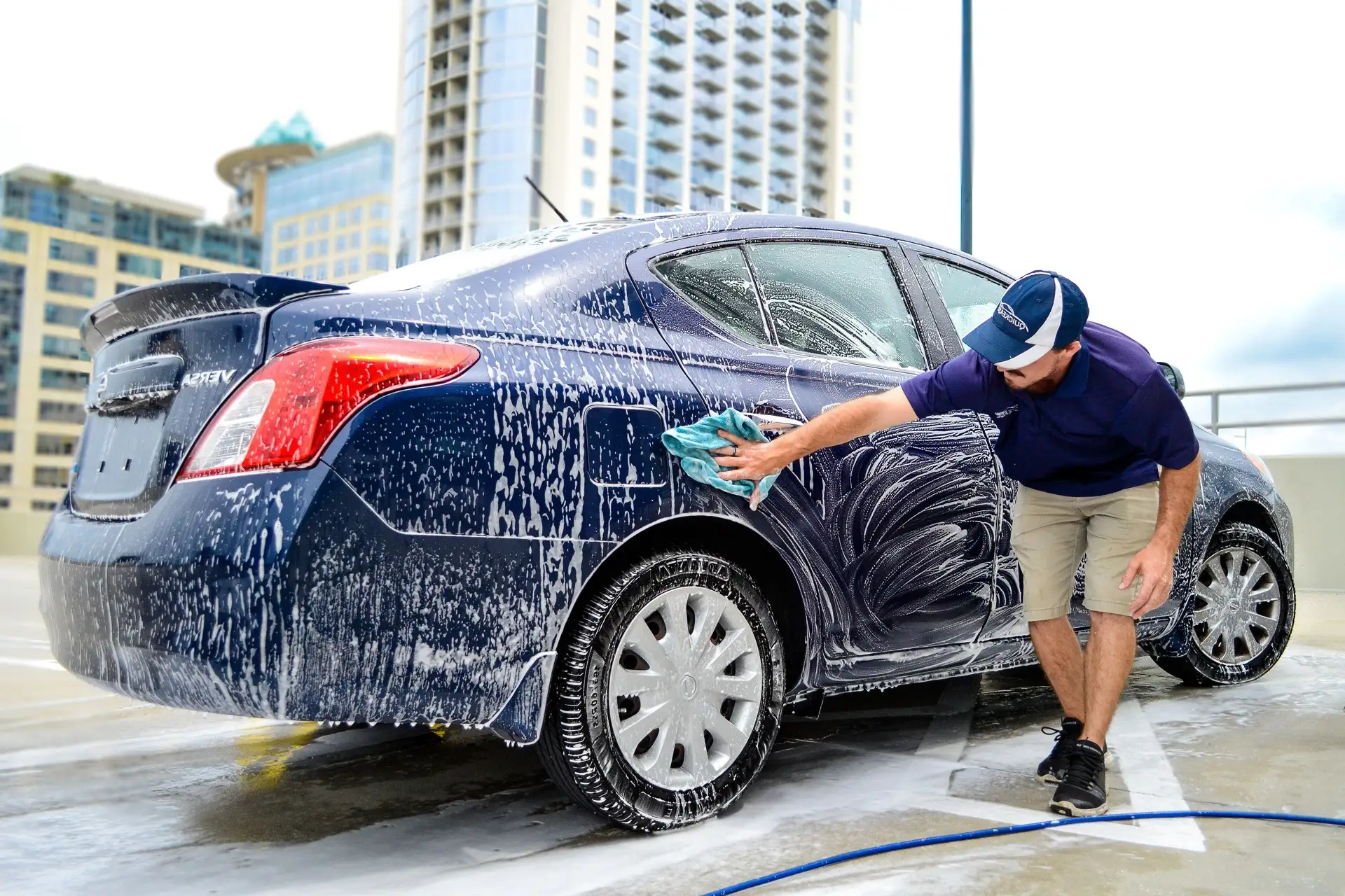 Quickease mobile detailer hand washing a vehicle